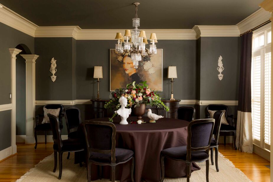 The fringed natural-fiber rug (find a similar one here) grounds the moody dining room, ensuring that its drama never tips over into melodrama.
