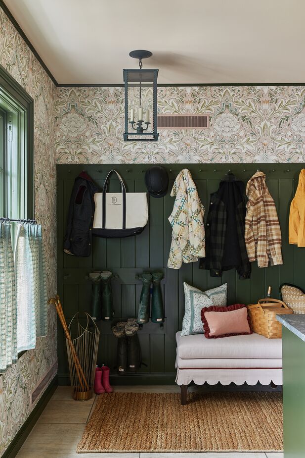 Katy Evans Design used a William Morris wallpaper and a scalloped skirt on the bench to dress up this hardworking mudroom. Photo by Heather Talbert.

