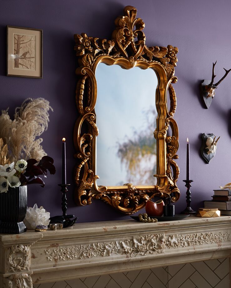 The ideal complement to an ornate marble mantel? An equally ornate gold-framed mirror.  
