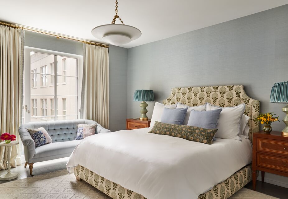 In the primary bedroom as well as the rest of the home, Jennifer used timeless silhouettes and textiles to offset the lack of classic moldings. Find similar table lamps here and a similar ceiling fixture here.
