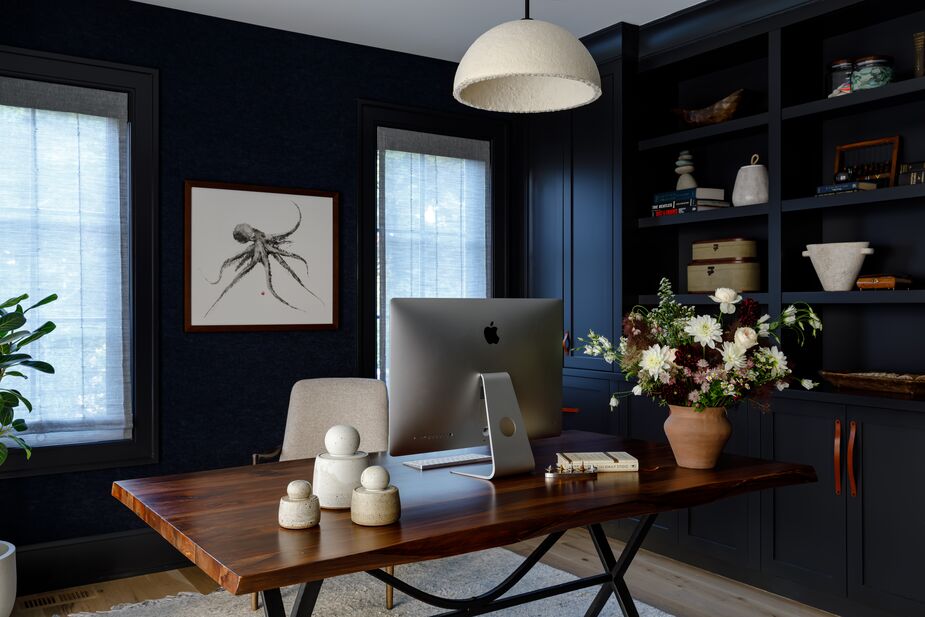 “I take great delight in guiding clients toward embracing the allure of the darker side in their interiors,” Becky says of the home office’s palette. The live-edge walnut desk was originally a dining table before being cut to fit into the new space.
