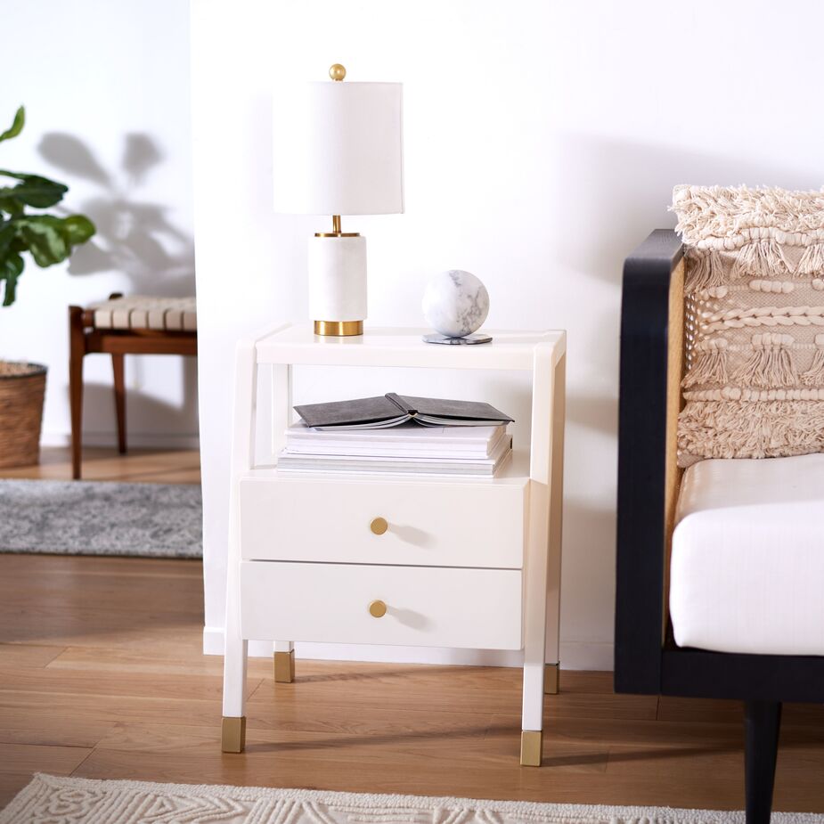 Along with two handy drawers for hiding distractions, the Zeph Accent Table has open surfaces for resting a lamp and a beverage as well as for displaying favorite objects. Find a similar pillow here. 
