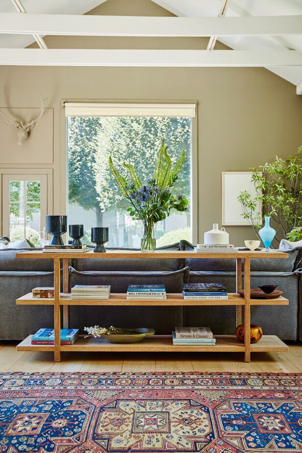 The deep blue hue of the Set of Three Berkeley Urns atop the Collector’s Oak Console echoes the rich blue of the vintage rug, while their glossy finish provides a counterpoint to the room’s other textures.   
