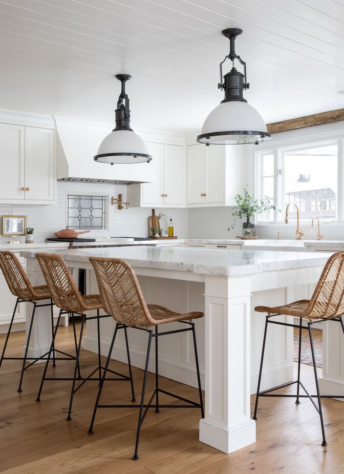 The open-weave stools and the wood beam above the window ensure that the kitchen maintains the same organic appeal as the rest of the home.
