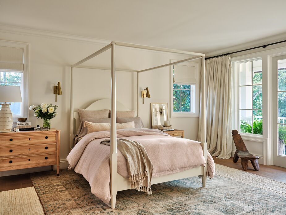 The Allaire Oak Canopy Bed plays well with both traditional and contemporary pieces, as seen here, where it’s accompanied by the Penelope Sconce in Brass and the Adams Three-Drawer Dresser in Limewash.
