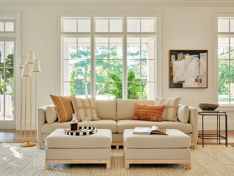 The golden Montreuil Floor Lamp and frame surrounding Jill Krasner’s Layering Geology add a curatorial flair to the more casual elegance of the Delano Performance Linen Sofa in Almond and the matching ottomans. The marble tops of the nesting tables provide more layers of refinement.
