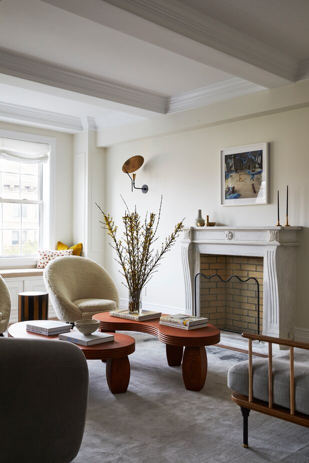 In the living room, curves abound, both traditional (the fireplace mantel) and modern (the chairs, tables, and as seen at top, the sofa). Find a similar sofa here.
