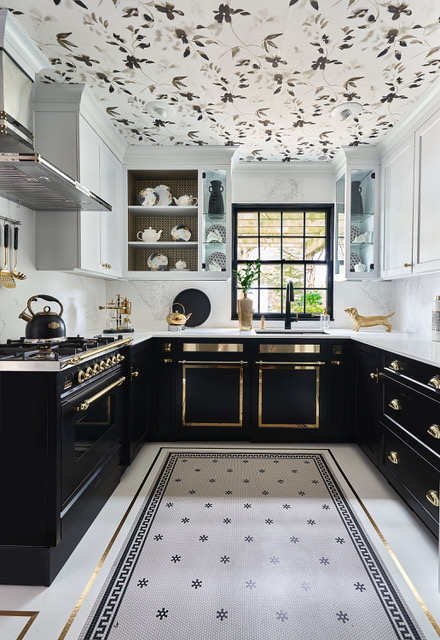 Given how dramatic the rest of the kitchen is—the gold-on-black range and lower cabinets, the tile “rug” outlined with more gold—a plain white ceiling simply wouldn’t do. Instead, Lori Lennon & Associates balanced all that luxe by papering the ceiling with a black-and-white floral motif.
