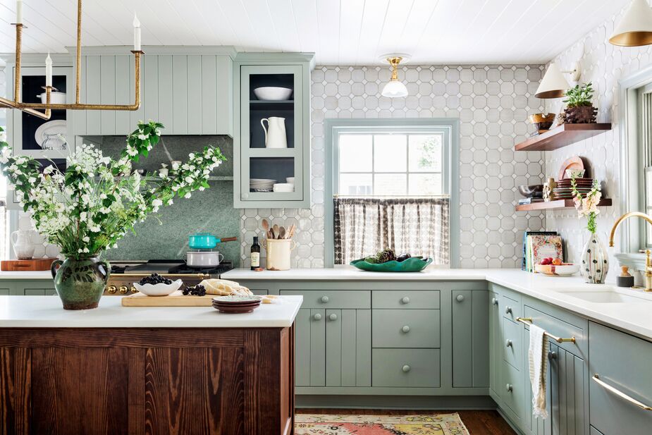 Visible from the living and dining rooms, the kitchen is a restful backdrop—though at the far end of the island, a trio of stools upholstered in bold yellow leather reinforce Susie’s vibrant style.
