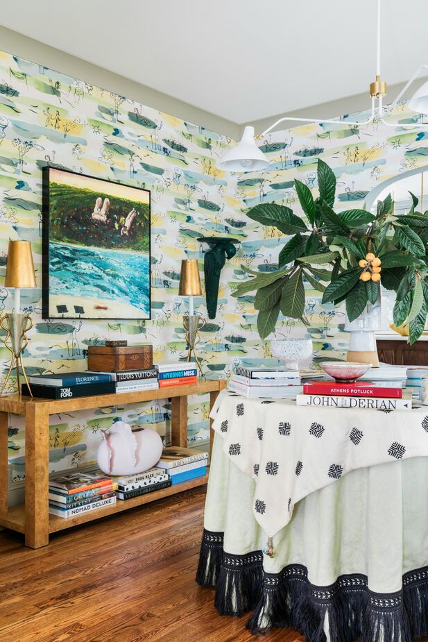 Another example of a library/dining area, designed by Tami Ramsay of Cloth & Kind. (See more of the home here.) The expandable skirted table is ideal for hiding books under. Find a similar chandelier here. Photo by Robert Peterson. Styled by Frances Bailey.
