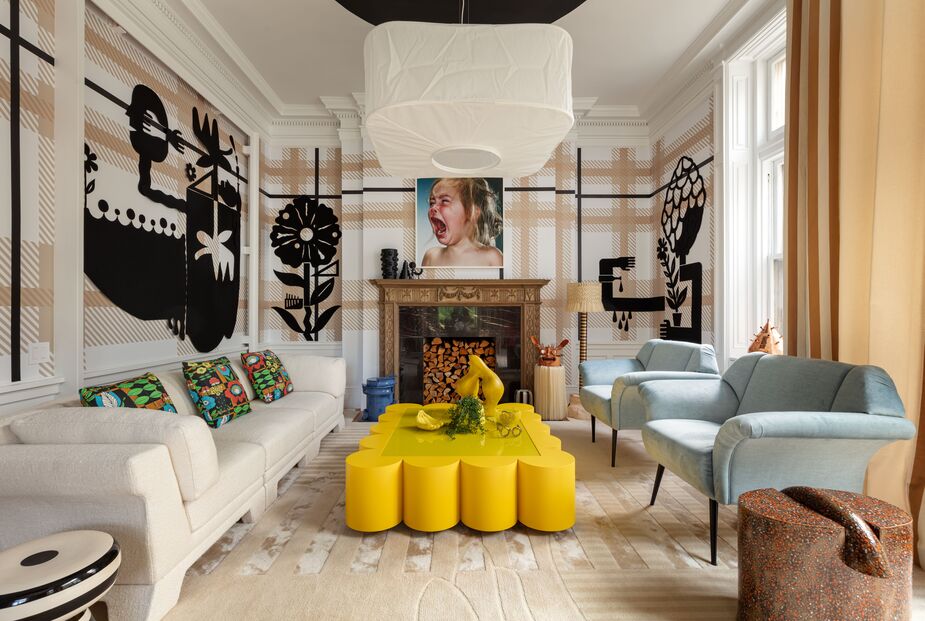 Two of the mansion’s previous owners, Shakespearean actress Julia Marlowe and businessman (and Seagram heir) Edgar Bronfman Jr., inspired Ghislaine Viñas‘s design of this sitting room. The plaid wallpaper and striped drapery nod to the businesslike aspect; the paint and felt overlays on the walls and the custom coffee table definitely bring the drama. 
