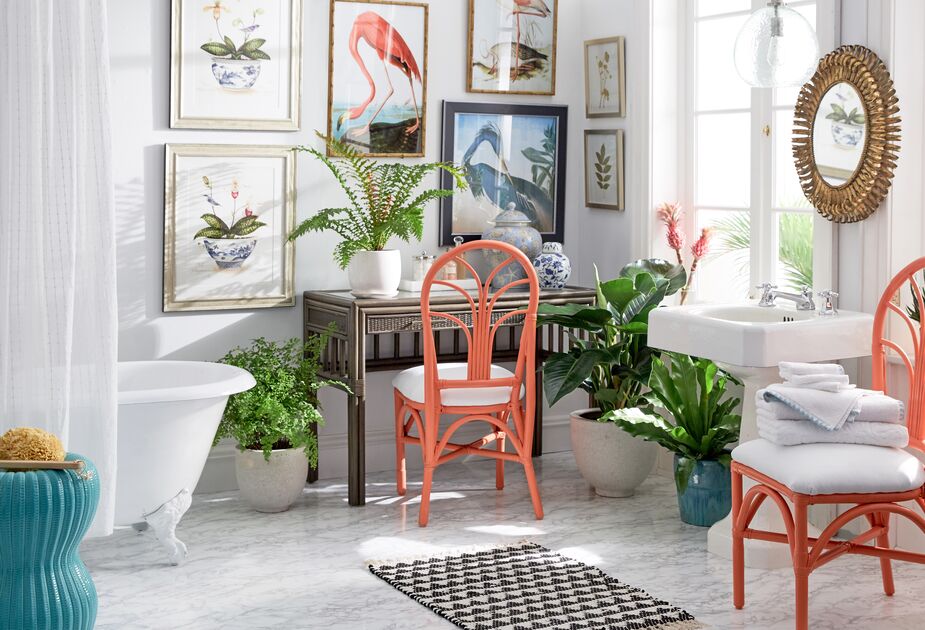 The orange chairs serve as palate cleaners in this biophilic bathroom.
