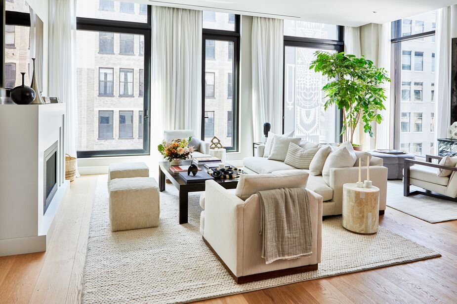 In this room by One Kings Lane Interior Design, the multitude of textures command attention amid the pared-down shapes and limited palette. The onyx veneer of the Greta Spot Side Table, the hair-on hide poufs, and the potted tree in the corner introduce welcome organic elements that prevent the space from feeling rarefied. Find the cable-knit wool rug here. Photo by Tony Vu.
