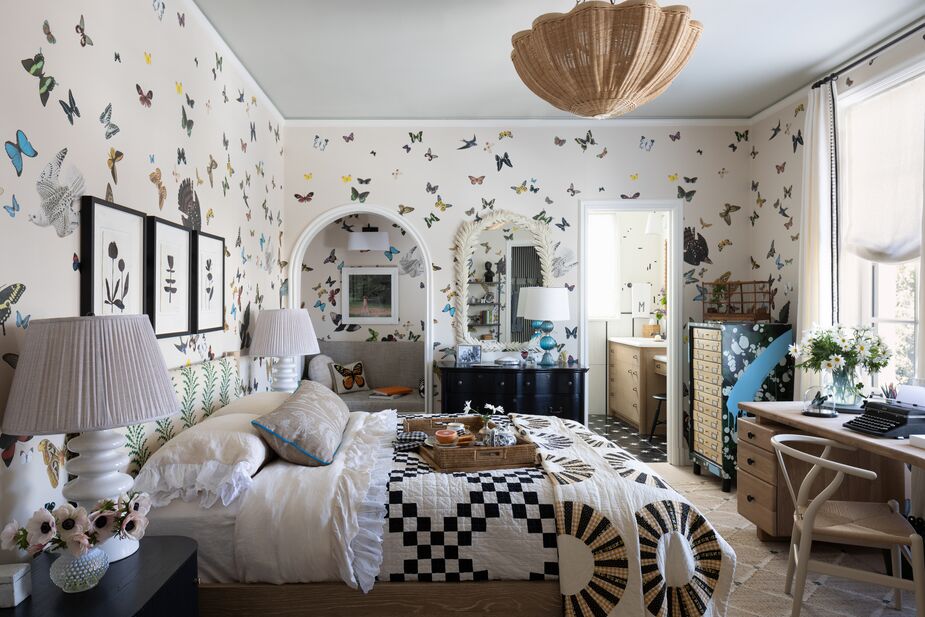 By integrating a few geometric motifs, including the diamond motif of the Kali Jute Rug, Chantal Lamberto ensured that this butterfly-adorned bedroom never felt too girly. The reading nook the arched doorway adds “secret garden” charm. Find the nightstand lamps here and a similar desk chair here. Photo by Bess Friday.
