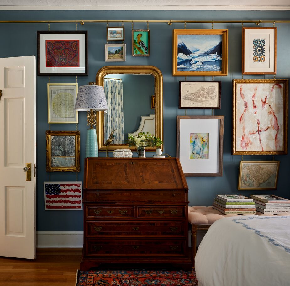 In the primary bedroom as well as in the living room, Lathem installed gallery rails to hang art from, minimizing the number of holes that had to be put in the walls and making it easier to switch out art. Find a similar wall mirror here. 

