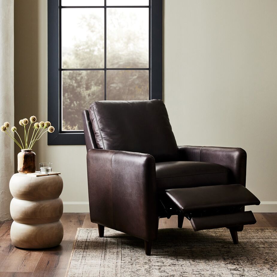 What’s more relaxing than kicking back in a recliner with a good book? Kicking back in a recliner, such as the Newman Recliner Chair, that’s as handsome as it is comfortable. Also shown: the Sai Hand-Carved Reclaimed-Wood End Table.
