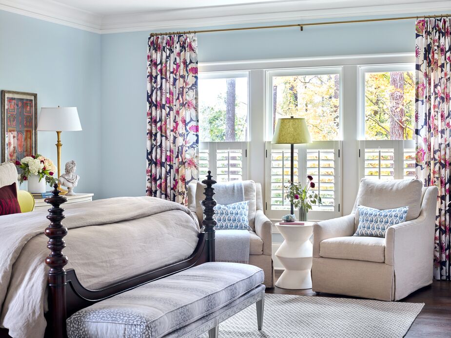 Lively floral curtains and the dark wood of the carved bed frame provide just enough contrast to enliven the main bedroom’s pastels without disturbing the serene ambience. 
