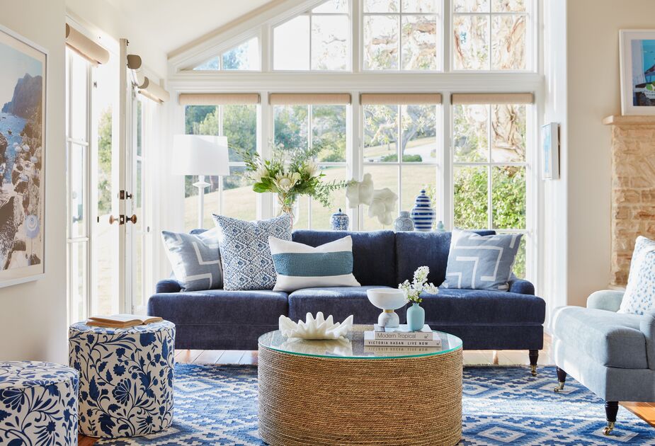 The limited palette enables the various prints to work together harmoniously. It also helps that the largest piece, the Isadora Performance Velvet Sofa in Indigo, is a solid color. Find the Harper Vine Floral Ottomans here; find the striped ginger jar here. Photo by Joe Schmelzer.
