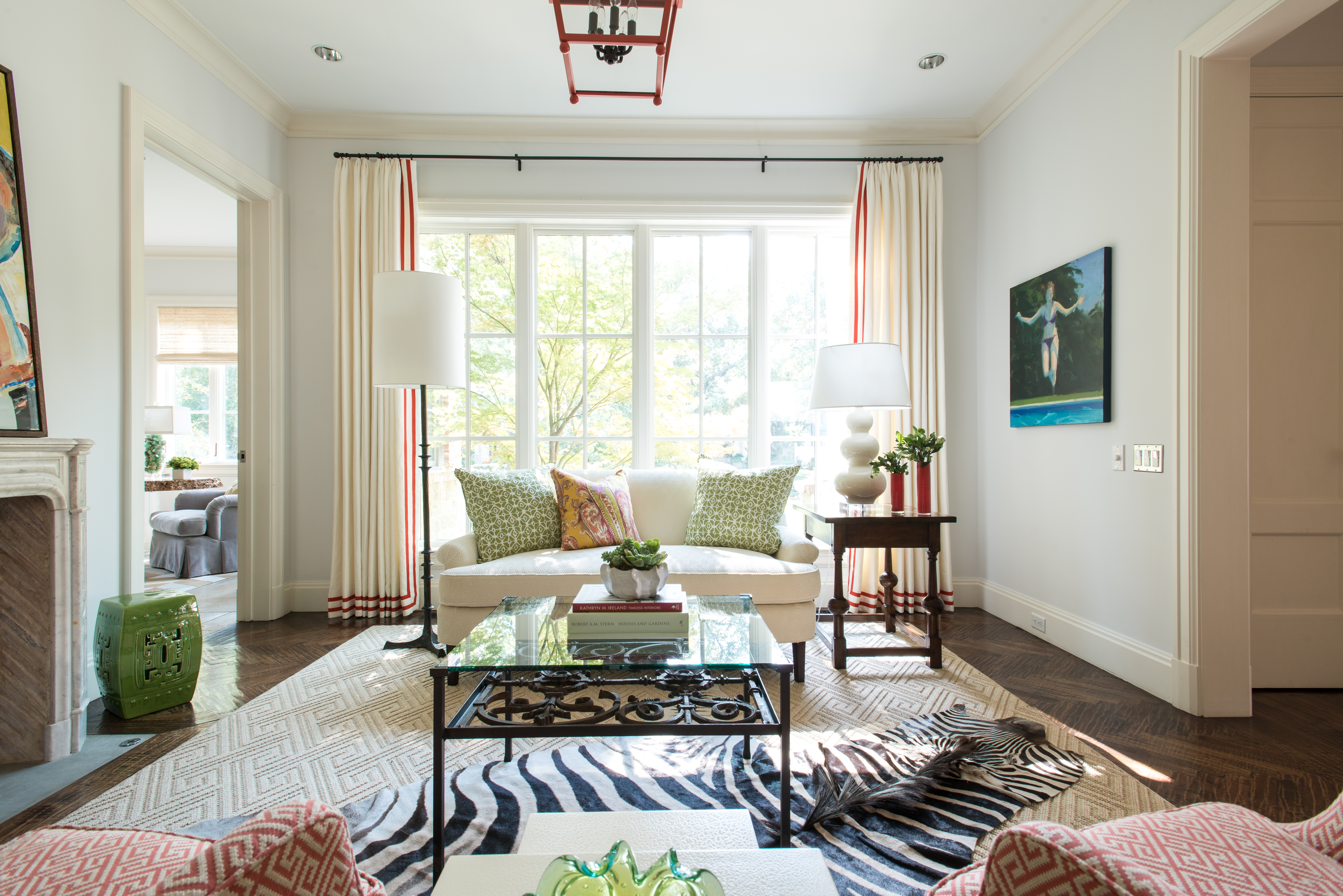 “I love the living room,” Kara says. “Those are the favorite drapes I’ve ever done. That red trim is fabulous. We spent many hours making sure those drapes were perfect.” Find a similar zebra rug here and an array of gourd lamps here.
