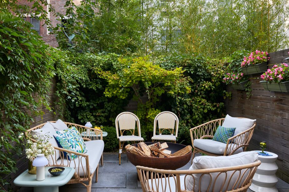 The home’s private garden accommodates both a dining area and this cozy sitting area. Find similar bistro chairs here. 

