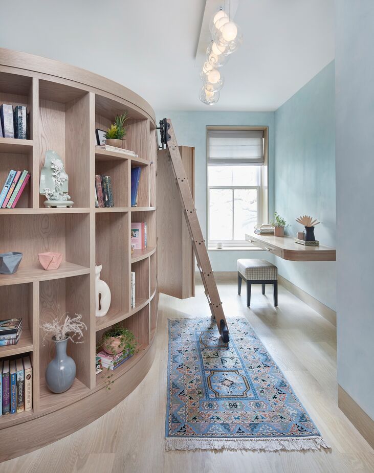 A tale of two bedrooms: With its cloudlike ceiling fixture, rope bridge, and two-story treehouse (minus the tree), the younger daughter’s bedroom is a world unto itself. The older daughter’s room taps into her love of reading, with a door within the bookcase leading to a hidden nook.
