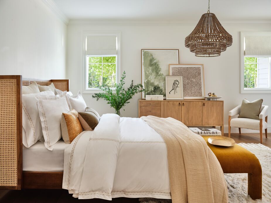 Velvet and mohair pillows and a hand-knotted wool rug warm up the room’s pale neutrals. Also shown above: the Aimee Can Wingback Bed in Natural, the Hazel Waterfall Bench in Ochre, and the Silas 6-Light Chandelier. Photo by Read McKendree.
