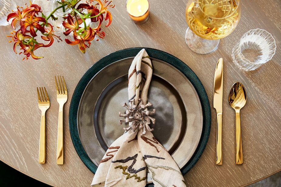 Stoneware Dinner Plates in Pewter, Academy Flatware in Gold, cloth napkins, and luxe napkin rings make even leftovers feel special.
