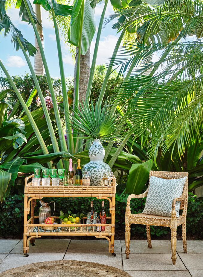 The wheels and handles of the James Rattan Bar Cart make it easy to move your drinks station anywhere—including back indoors once the gathering is over. Photo by Read McKendree.
