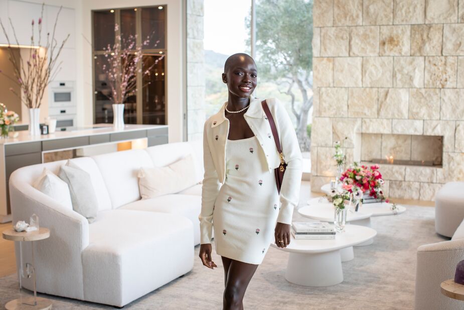 Model SouKenya Diouf in front of the Serenity Left-Facing Sectional in Cottony Ivory and the Tranquility Nesting Cocktail Tables. Photo by Erika Hokanson.
